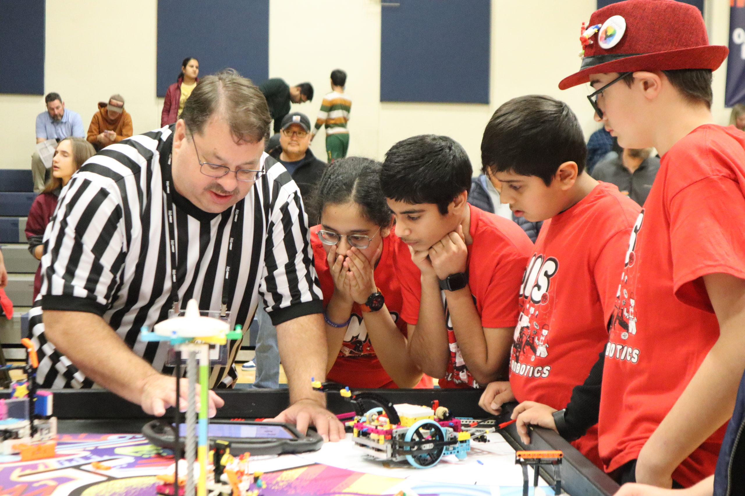 FLL team Twisted Gears at the January 2024 Columbia tournament. Team is consulting with the referee at the end of their match.